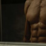 topless man in black shorts